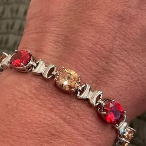Stainless steel orange and red topaz tennis bracelet